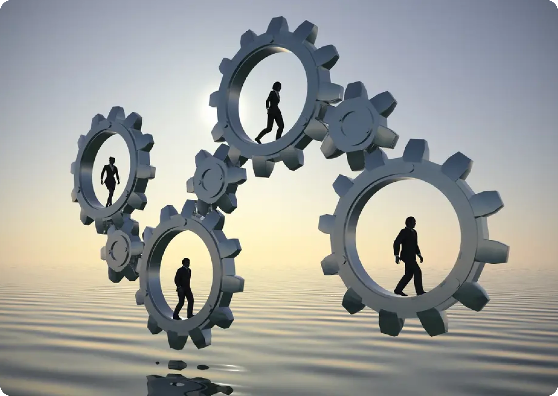 Silhouettes of people walking inside large interlocking gears above a reflective water surface, with a sunset background.